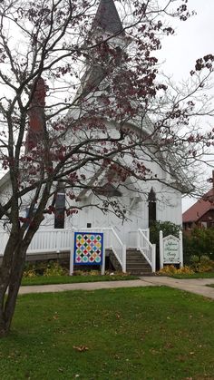 a white church with a quilt on the front