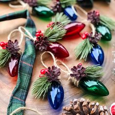 diy christmas light tree ornaments with pine cones and red berries