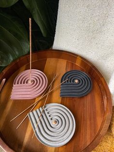 three coasters sitting on top of a wooden tray