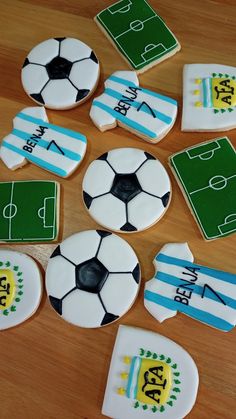 soccer cookies decorated with fondant and icing on a wooden table, ready to be eaten