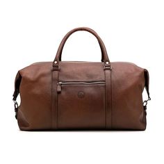 a brown leather duffel bag on a white background, with the handle extended and two zippers at the bottom