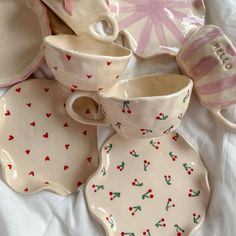 a table topped with dishes and cups covered in frosting