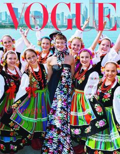 a group of women in colorful dresses posing for a photo on the cover of a magazine