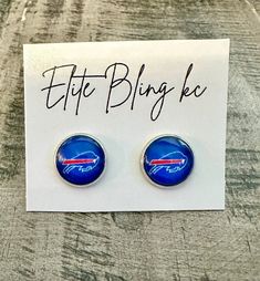 a pair of blue earrings with the word,'little bling blec '