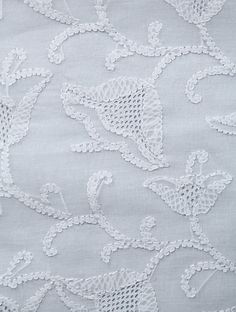 white lace with flowers and leaves on grey fabric