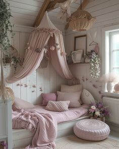 a bed with pink sheets and pillows in a room