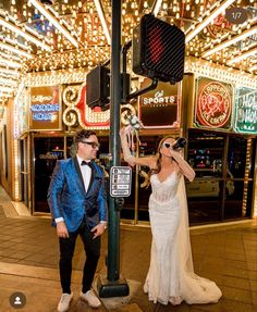 a man and woman standing next to a traffic light