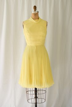 1960s Dress | Joseph Magnin  | Vintage 60s Dress Lemon Yellow Chiffon Cocktail Party Dress Accordion Pleats  DETAILS:  *1960's era *Lemon yellow poly chiffon fit and flare cocktail dress *Fitted bodice *Bias band roll collar  *Sleeveless *Accordion pleat skirt with lettuce hem *Fully lined *Back lapped zipper LABEL: Joseph Magnin. Joseph was the son of the owners of the upscale I Magnin department stores and fashion label. He struck out on his own and had several stores as well. CONDITION: Excellent. Small faint mark on front bodice. Does not distract. Zoom in on third photo.  MEASUREMENTS:  Bust=34" Waist= 26" Hip= 38"  Length from high point shoulder to hem= 38" Compare with your own measurements + ease or compare with similar garments in your closet.  SHIPPING: This item will ship via U Fitted Chiffon Vintage Dress For Party, 1950s Style Spring Cocktail Dresses, Vintage Pleated Party Dresses, Mid-century Summer Party Dresses, 1950s Vintage Dress For Spring Party, 1950s Style Vintage Dress For Spring Party, Vintage Fitted Chiffon Dresses, 1950s Style Cocktail Dress For Spring, Retro Silk Dress For Vintage Fashion