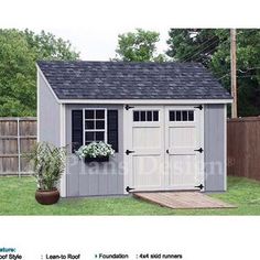 a small shed with a plant in the yard next to it and a potted plant