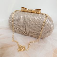 Please note I am currently on a short break, all orders placed will be shipped on Monday 28th October 2024.  Make a grand entrance with our Rhinestone Egg-Shaped Evening Clutch. Featuring a shimmering rhinestone fabric and finished in a glamorous gold tone, this clutch is the epitome of elegance. The egg-shaped design offers a contemporary twist, while the satin-lined interior ensures your essentials are kept in luxurious comfort. Key Features: -  Material: Glittering rhinestones with a durable Rhinestone Fabric, Cosmetic Design, Wedding Bag, Handmade Gift Wrap, Grand Entrance, Gold Rhinestone, Egg Shape, Formal Attire, Evening Clutch