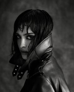 black and white photograph of a woman with dark hair wearing a leather jacket over her shoulder