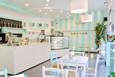 the inside of a restaurant with many tables and chairs in front of an ice cream shop