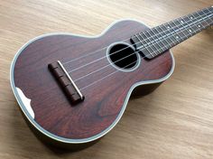 a ukulele sitting on top of a wooden table