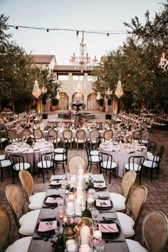 an outdoor dining area with tables and chairs set up for a formal function in the evening