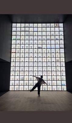 a person standing in front of a large display of shoes