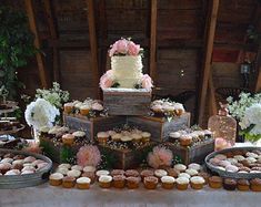 a table topped with lots of cupcakes and cakes