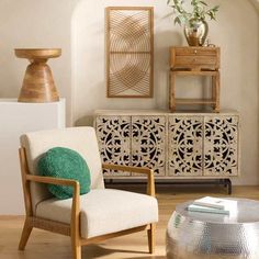 a living room scene with focus on the chair and sideboard in the foreground