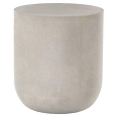 a white concrete vase sitting on top of a table