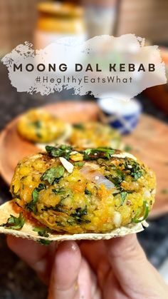 a person holding up a piece of food with the words moong dal kebab healthy eatswhat