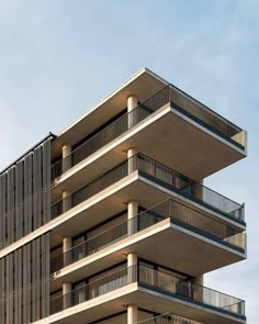 a tall building with balconies on the top and second story balconyes above it