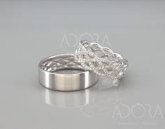 two wedding rings are shown on a gray surface with the words asosca above them