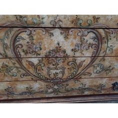 an old chest with ornate designs painted on it