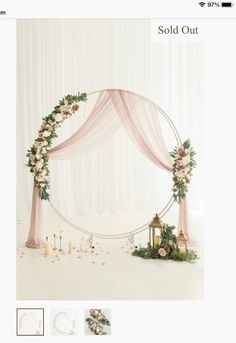 a wedding arch decorated with flowers and candles