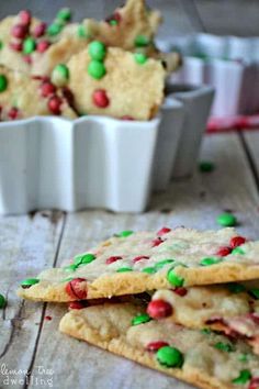 some cookies with candy and sprinkles are on a table