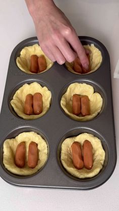 six cupcakes in a muffin tin with hotdog buns on top