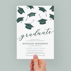 a hand holding up a card with graduation caps on it and the words graduate written in black ink