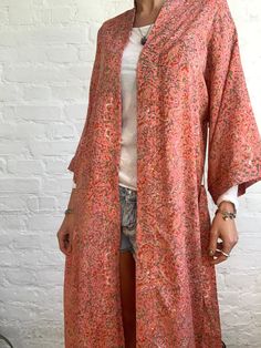 "This is beautiful silky upcycled robe in coral colour with delicate floral print Made free size with wrap tie closing and wide kimono sleeves Easy and fun to wear around the house or can be used on holidays as a beach cover up It is very comfy and feels soft and light the material is colourful indian saree silk made into this unique stylish over all MEAESURE free size length 55\" MATERIAL *saree silk, no lining more available at https://www.etsy.com/shop/AltheaStores? CARE INSTRUCTIONS * Wash i Spring Kimono With Relaxed Fit, Spring Silk Wrap Robe, Spring Sleep Robe With Kimono Sleeves, Spring Wrap Robe With Relaxed Fit, Fall Loungewear Robe With Kimono Sleeves, Spring Wrap Robe For Sleep, Spring Wrap Sleep Robe, Long Sleeve Silk Robe For Home, Silk Long Sleeve Home Robe