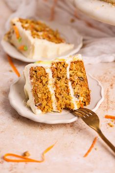 a slice of carrot cake on a plate with a fork