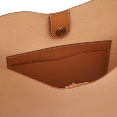 A shoulder bag in bio-tanned cowhide leather, shaped on beech wood frames. Its essential design features the unmistakable iconic wave contour. Magnetic snap closure. Unlined with large open leather pocket. 100% made in Italy and produced in the province of Florence by master artisans in Il Bisonte's 30-Km supply chain. Made by Il Bisonte in Italy CONTENT & CARE:100% Cowhide with brass hardware MEASUREMENTS:12,99(W), 14,57(H), 2,36(D) inch Modern Beige Bucket Bag With Leather Lining, Travel Bucket Bag In Beige With Smooth Grain, Modern Light Brown Shoulder Bag, Everyday Calf Leather Shoulder Bag With Smooth Grain, Calf Leather Shoulder Bag For Everyday Use, Smooth Grain Top Handle Hobo Bag For Travel, Modern Beige Shoulder Bag With Leather Lining, Modern Beige Satchel With Leather Lining, Modern Light Brown Tote Shoulder Bag