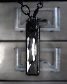 A bit of grit + sparkle... the TWILIGHT necklace features a sleek, soft grey 'Black Diamond' color crystal pendant, suspended on a matte black chain. The other side of baguette crystal pendant is an opaque dark silver metallic coat. The lobster clasp can be connected to the pendant, or anywhere along the length of the chain for an adjustable 'Y' style (up to 19" length). The tall, thin rectangular crystal (1-1/2" tall, 3/8" wide) has been set in a blackened and slightly-distressed, hand-soldered bezel. This modern-minimalist jewelry piece is perfect for dressing up or down... this versatile design elegantly accents a scoop-neck top, or looks super-sexy with a low-cut plunging neckline! THE DETAILS: 'Black Diamond' soft grey rectangular crystal: 1-1/2" tall, 3/8" wide (4cm x 1cm) Hand-solde Twilight Necklace, The Lobster, Crystal Pendant Necklace, Black Plates, Black Chain, Black Hand, Crystal Necklace Pendant, Diamond Color, Diamond Crystal