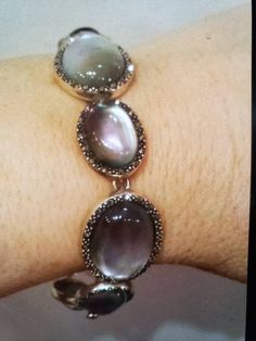 "Truly elegant and still cool! Ovals alternate sizes of larger 22x17mm and smaller 17x13mm. 7 1/4\" length, 11/16\" at widest point; Hidden box-insert clasp; NATURAL Gray Mother-of-Pearl ovals that are topped with Clear Quartz for protection, and framed by Marcasite for SPARKLE☺ The gray Mother-of-Pearl shows all the colors of silver, pink, and pistachio green. Hallmarked SLC 925 THAILAND *Brand New* Contact me with any questions" Elegant Silver Oblong Jewelry, Silver Oval Cabochon Bracelet, Elegant Silver Cabochon Bracelets, Elegant Bracelets With Natural Stones, Elegant Natural Stones Oval Bracelet, Formal Adjustable Oval Bracelet, Silver Oval Beads Jewelry For Formal Occasions, Oval Cabochon Bracelets For Formal Occasions, Formal Silver Jewelry With Oval Beads