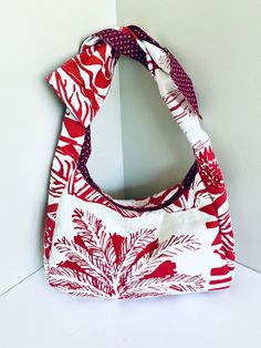 Description: Large Red and white summery print Bohimian style Hobo canvas bag with zipper closure.  It features 3 pockets inside including one with a 10 inches long zipper.  Using the two straps to tide a knot on top to decide how you are using the bag, whether a crossbody bag, a shoulder bag or a handbag.  The choice is yours.  It is lightly padded to protect your items.  Made with canvas and cotton fabrics. Measurements: 17 inches W x 10 inches H x 4.5 inches D Both straps are 22 inches long ( Casual White Reversible Shoulder Bag, Red Cotton Beach Shoulder Bag, Padded Bag, Crescent Bag, Pad Bag, Hobo Bags, Hobo Handbags, Hobo Bag, Canvas Bag