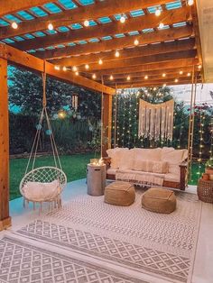 an outdoor living area is lit up with string lights