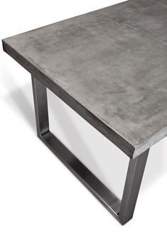 a concrete table sitting on top of a metal frame