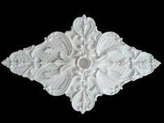 a white decorative object on a black background