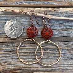 Gold Plated Hammered Hoop Earrings with a Red Czech Glass Flower. Includes Nickel Free Ear Wires. These earrings are light weight, comfortable, simple and fun. Throw them on with any outfit and they will definitely add some pop! They are approximately 2.75 inches in length and 1.25 inches at the widest portion. If you would like these in a different color or size, please let me know as I also do custom orders. To view more of my original jewelry designs, visit: https://www.etsy.com/shop/TheBeadC Unique Red Flower Earrings, Red Bohemian Circular Jewelry, Red Round Flower Earrings With Ear Wire, Adjustable Nickel-free Red Hoop Earrings, Red Brass Earrings With Ear Wire, Handmade Red Flower Earrings, Bohemian Red Metal Hoop Earrings, Artisan Nickel-free Red Earrings, Artisan Red Nickel-free Earrings