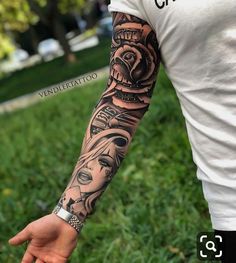 a man is holding his arm with tattoos on it