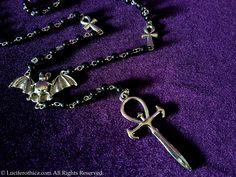 Vampyr Ankh Rosary. One of a kind vampiric rosary with 2 small ankhs coming together at a bat center piece. At the end of the rosary a very unqiue vampire Ankh piece (6cmx3cm). Silver colour. Worldwide Shipping More jewellery, accessoires, altar equipment and much more can be found at www.luciferothica.com © Luciferothica.com All Rights Reserved. Ankh Rosary, Vampire Ankh, Vamp Goth, Gothic Vampire, Rosary Necklace, Silver Colour, Gift Handmade, Rosary, Types Of Metal