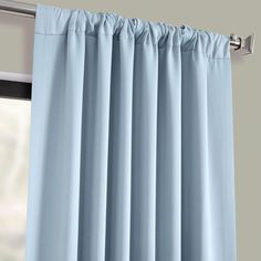 blue curtains hanging on the side of a window