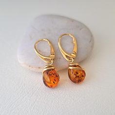 drop earrings with authentic amber material: 24 K gold plated on 925 silver and Baltic amber in cognac color dimensions drops: 0.9 cm x 1.1 cm total height: 3.1 cm clasp: sleeper weight: 3.10 gr hallmarked item shipping within 24 hours Formal Baltic Amber Drop Earrings, Elegant Gold Baltic Amber Jewelry, Elegant Baltic Amber Gold Jewelry, Formal Baltic Amber Earrings, Amber Dangle Earrings In Baltic Amber, Baltic Amber Drop Earrings, Teardrop Baltic Amber Earrings In Amber, Amber Teardrop Baltic Amber Earrings, Classic Gold Jewelry With Baltic Amber