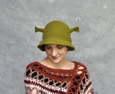 "Crochet Shrek bucket hat, Summer bucket hat, Animal hat More animal hats you can find here: https://etsy.me/3B4ySGh Green crochet hat with ogre's ears, perfect hat for Shrek lovers.  The hat is made of acrylic yarn, perfect for people allergic to wool.  My hats are crocheted in the round, without any seams inside. Size: circumference: 55-58 cm [21.3\" - 23.5\"] Color: green. Because of different monitors and screen resolutions, colors may look different on the screen than in reality. If you want such a hat in any other color or size please feel free to contact me. I will be happy to make it for you.  Care instructions: Hand washes in lukewarm water (30o C), dry flat.  More hats you can find here: https://etsy.me/2KDvlcU Please take a look at my shop policies before you order: http://www.e Cute Crochet Bucket Hat For Winter, Handmade Bucket Hat For Winter, Handmade Winter Bucket Hat, Whimsical Brimmed Bucket Hat, Novelty Bucket Hat, Cute Handmade Bucket Hat, Handmade Playful Brimmed Bucket Hat, Playful Handmade Brimmed Bucket Hat, Handmade Brimmed Novelty Hats