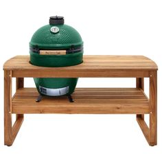 a big green egg sitting on top of a wooden table