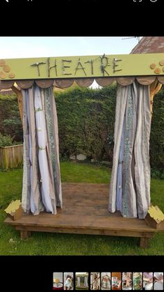 an outdoor stage with curtains and the words theatre written on it's front door