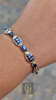 Looking for the perfect statement piece? This Sapphire 18k Gold Bracelet combines the beauty of vintage blue gemstones and a timeless gold design, making it a stunning choice for any September birthday or special occasion. A true treasure to cherish, this vintage bracelet is the ultimate gift for the woman in your life. Round Sapphire Bracelet, Fine Jewelry Sapphire Bracelets, Luxury Sapphire Bracelets For Anniversary, Luxury Sapphire Bracelet Jewelry, Elegant Blue Sapphire Diamond Bracelet, Luxury Blue Oval Diamond Bracelet, Fine Jewelry Sapphire Tennis Bracelet With 17 Jewels, Sapphire Gemstone Tennis Bracelet In Fine Jewelry Style, Fine Jewelry Sapphire Tennis Bracelet