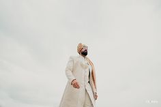 a man in a long white coat and turban