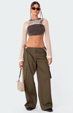 Stand out in streetwear-inspired style with these roomy cargo pants featuring flirty side cutouts, handy pockets and a low rise for a 2000s-inspired look. 100% cotton Machine wash, dry flat Imported Cargo Outfits Women Summer, Sheer Cargo Pants, Parashoot Pants Outfit, Olive Green Cargo Pants Outfit, Cargo Pants Low Rise, Low Waist Cargo Pants, 2023 Pants, Fits Check, Best Cargo Pants